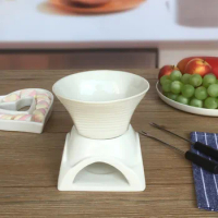 White ceramic fondue pot for chocolate and cheese melting