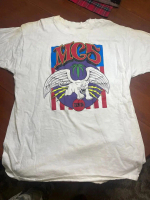 May include White t- shirt featuring a graphic design with the text MC5 in red, a winged white cat, 