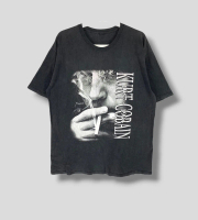 May include Black t- shirt featuring a black and white image of a person smoking a cigarette. The te