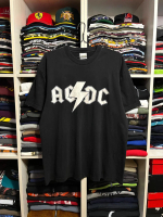 May include Black t- shirt featuring the band name ACDC in white block letters with a white lightnin