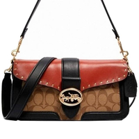 【COACH】黑x橘鉚釘x卡其橢圓立體馬車LOGO肩背斜背酒神包
