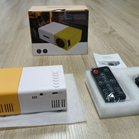 โปรเจคเตอร์ YG300 ขนาดเล็กยอดนิยม โปรเจคเตอร์ LED พกพาขนาดเล็ก HD สำหรับโฮมเธียเตอร์
