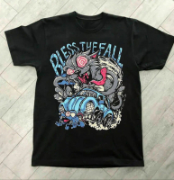 May include Black t- shirt featuring a cartoon graphic with the text BLESS THE FALL. The design incl