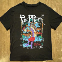 May include Black t- shirt with a colorful graphic featuring a stylized figure with a fish- like bod